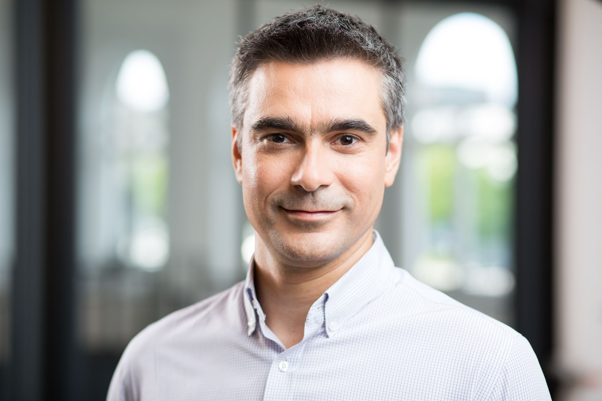 Portrait of Dobrin Mirevski, in a bright room standing in front of a window