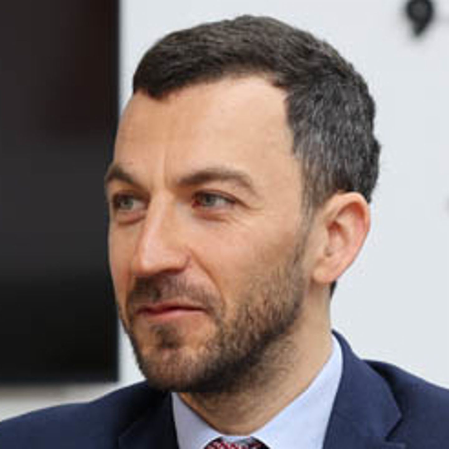 Vladislav Hadjidinev CEO of UNIBANKA is sitting at an office desk with a red folder in front of him